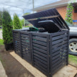 black composite garbage bin enclosure/shed on the side of a house