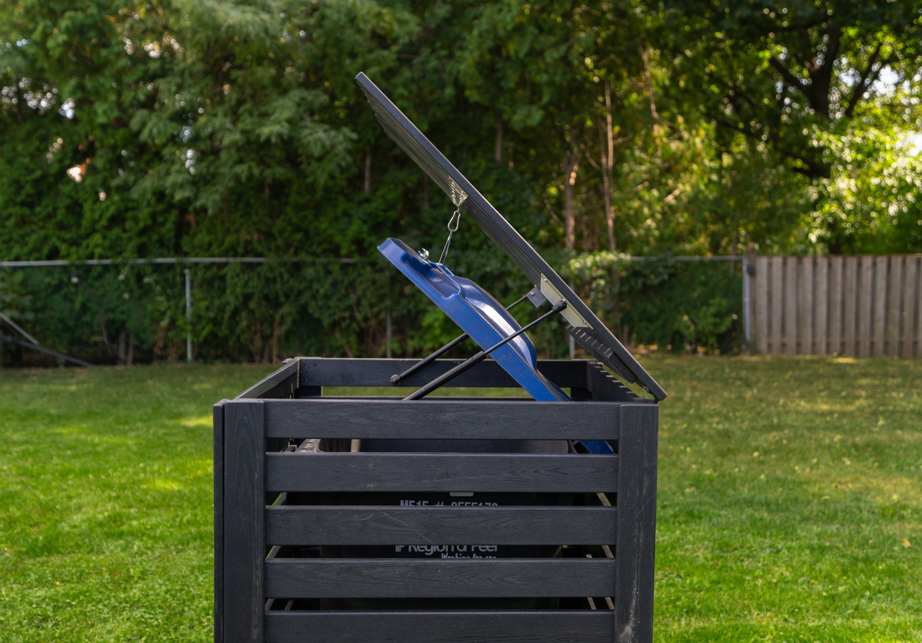 side view of Critter-proof single garbage bin shed built with sustainable composite plastic and a reinforced aluminum frame